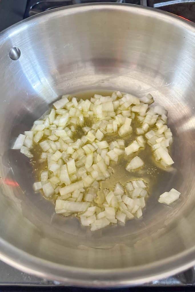 Chopped onions in a pan on the stove.