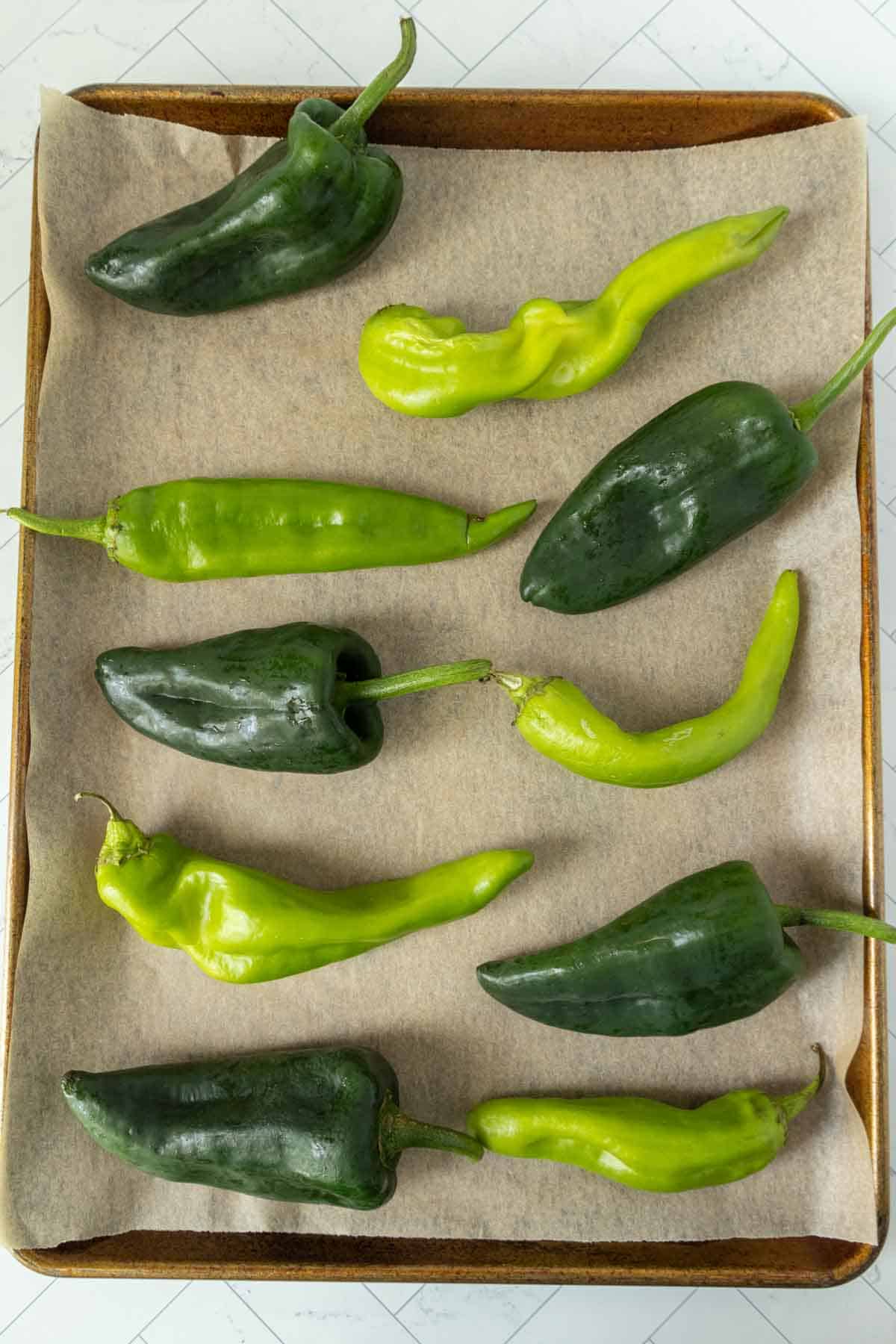 A tray of green and peppers on a table.