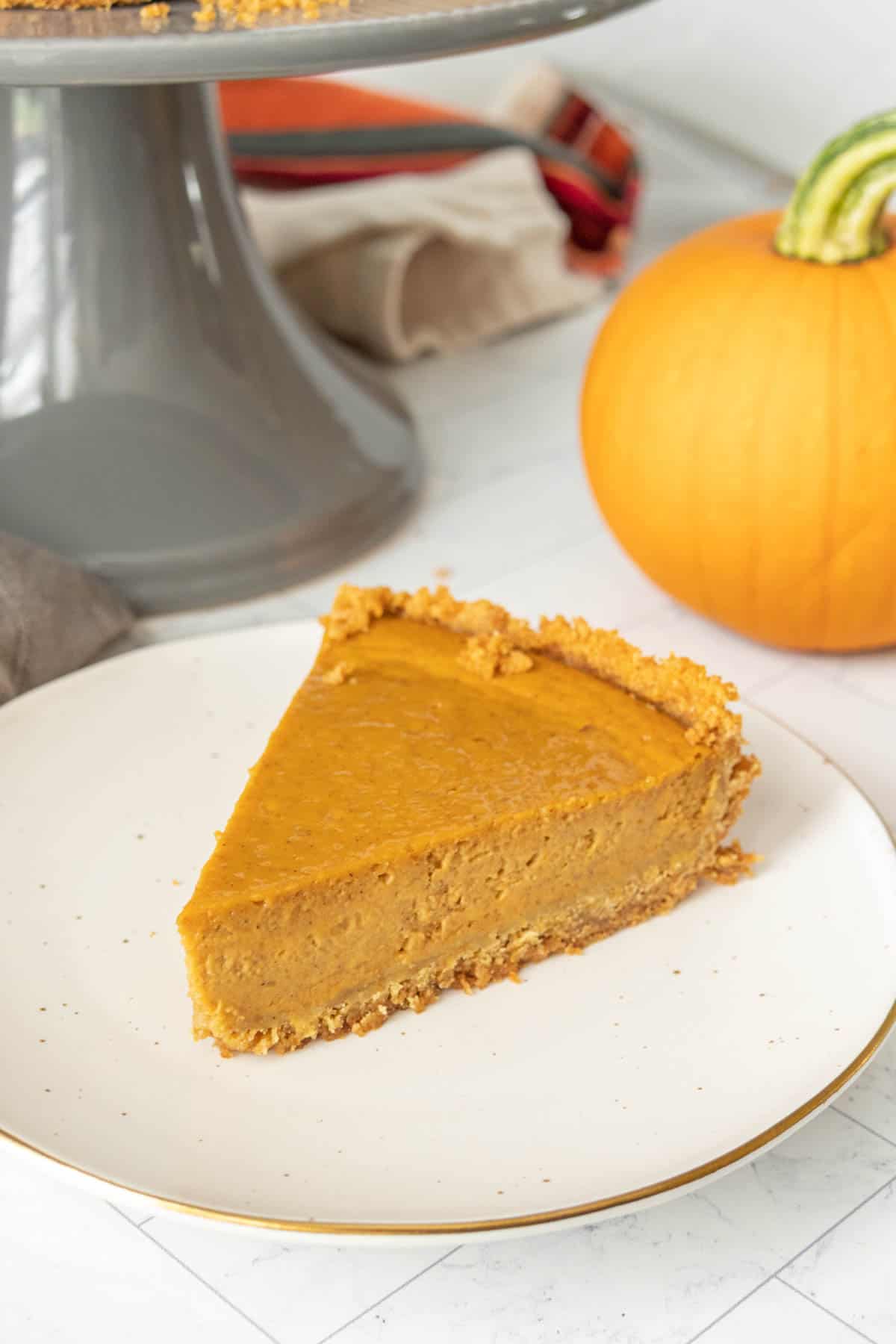 A slice of pumpkin pie on a plate.