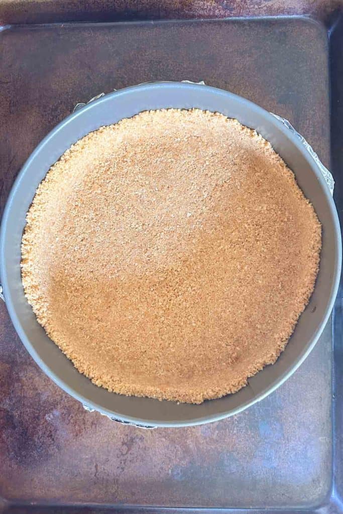 A pie crust sitting on a baking sheet.