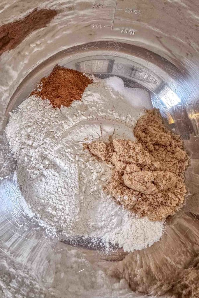 A bowl of flour and other ingredients in a metal bowl.