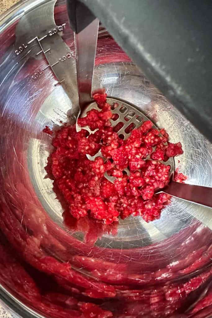 Raspberries in a food processor.