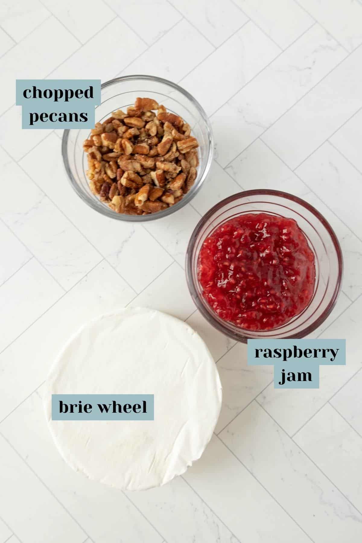 The ingredients for a baked brie with jam and pecans.