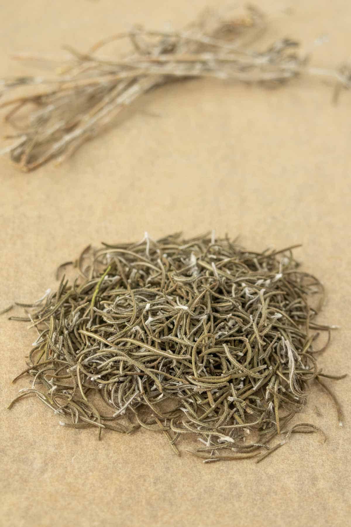 A pile of dried rosemary on a table.