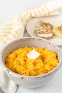 A bowl of mashed butternut squash with butter.