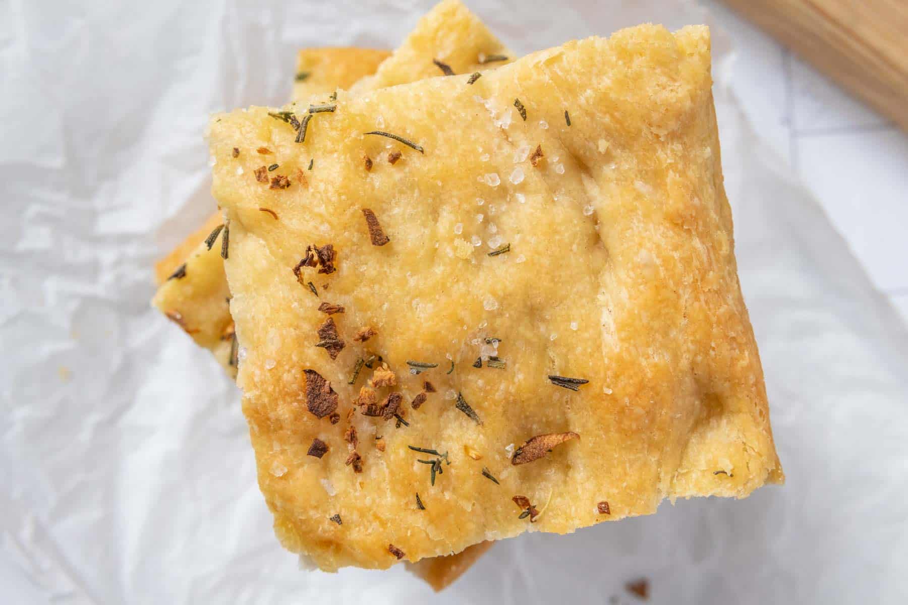 A piece of bread with herbs on it.