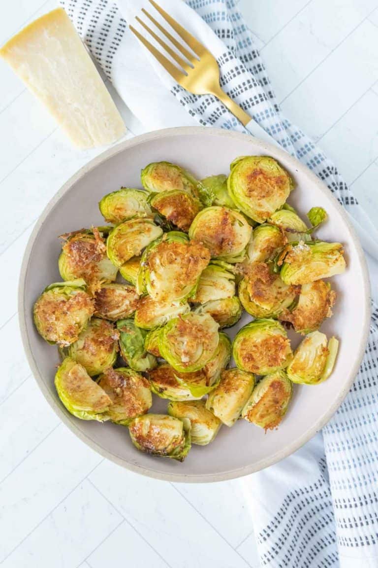 Roasted brussels sprouts on a plate with a fork.