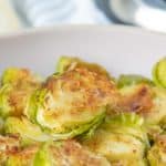 Roasted brussels sprouts in a white bowl.