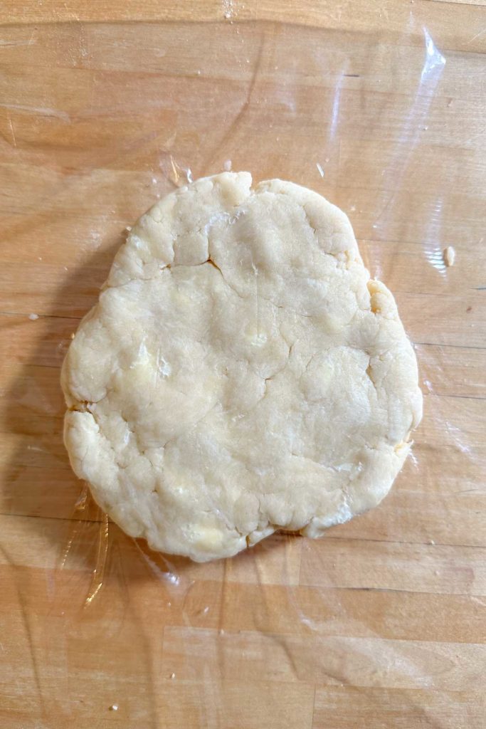A piece of dough sitting on a cutting board.