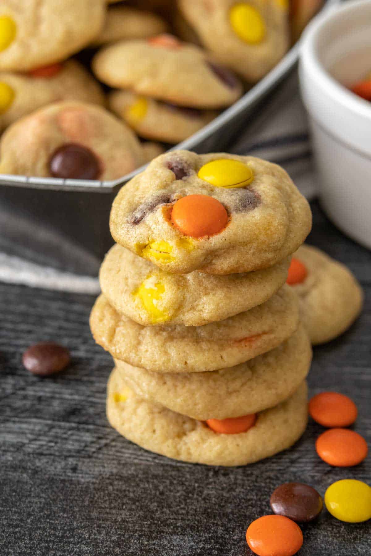 A stack of candy cookies on a plate.