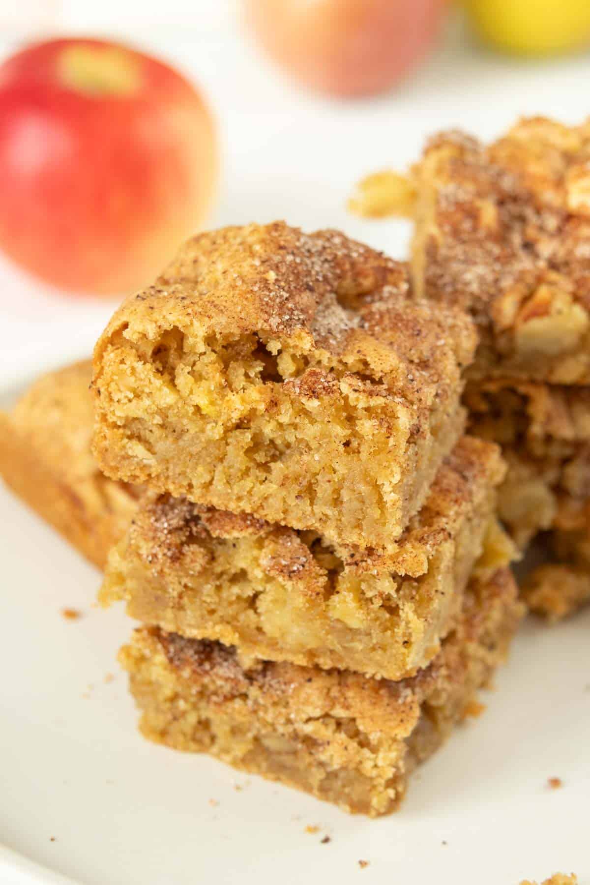 A stack of apple squares on a white plate.