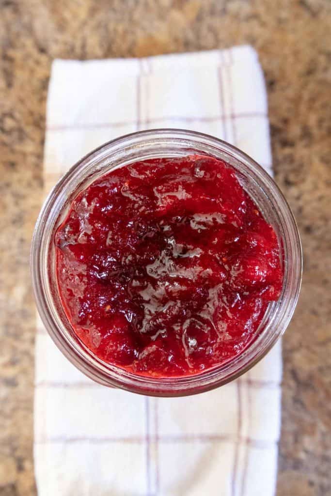 A jar of cranberry sauce on a napkin.