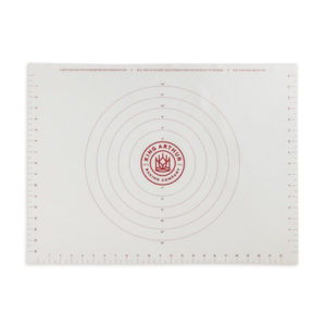 A white baking mat with a red circle on it.