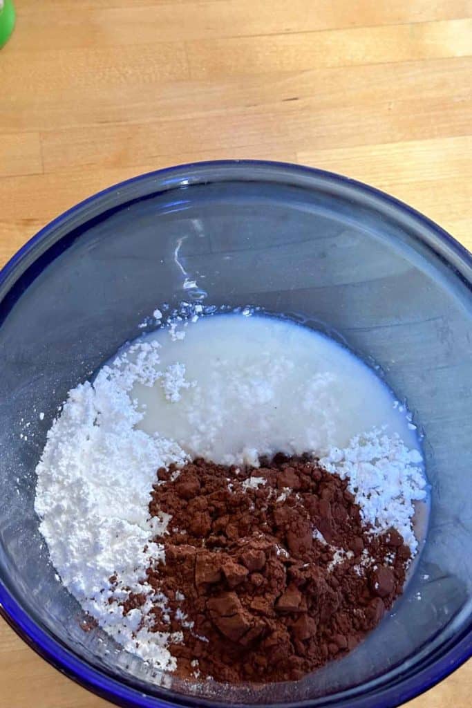 A bowl with powdered sugar and cocoa powder in it.