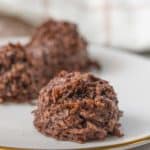 Chocolate macaroons on a plate.