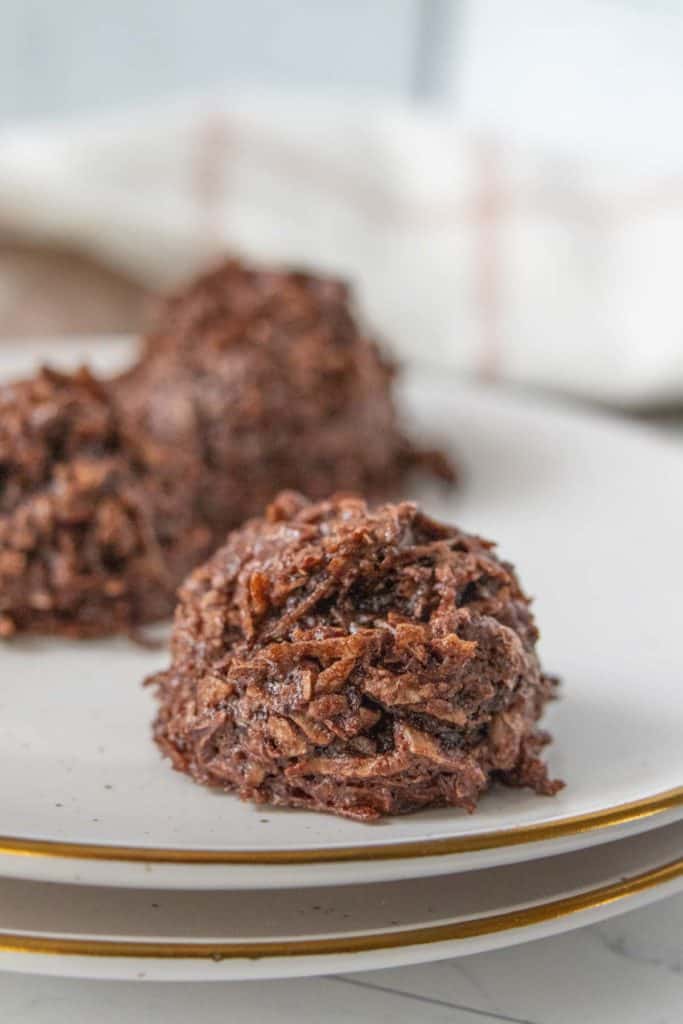 Chocolate macaroons on a plate.