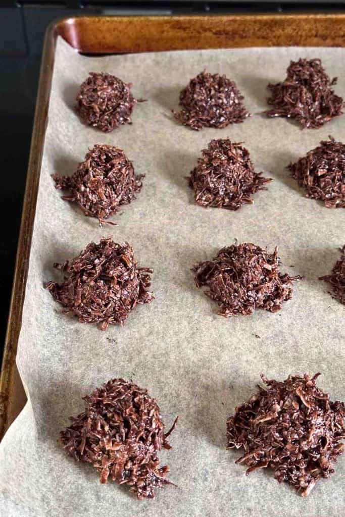 Chocolate macaroons on a baking sheet.