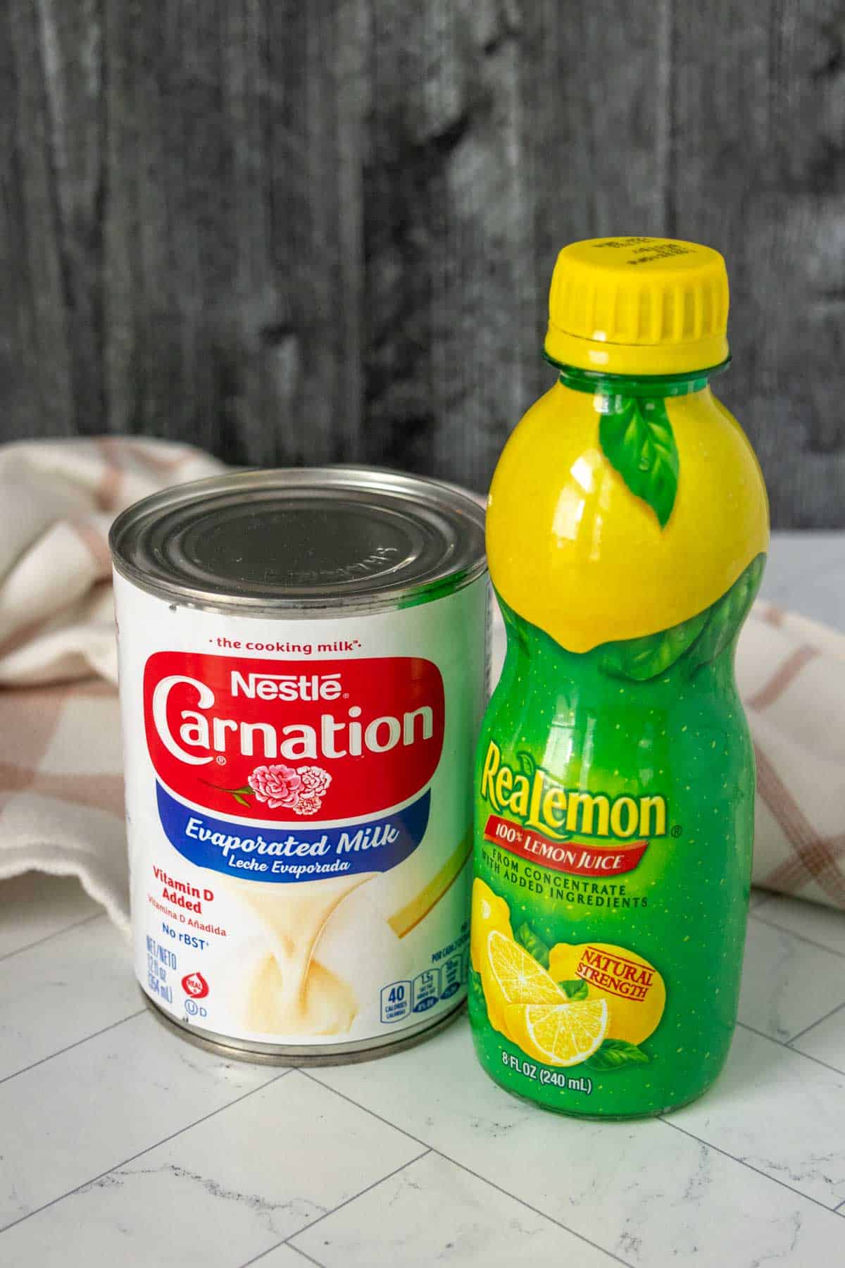 A can of evaporated milk and a bottle of lemon juice.