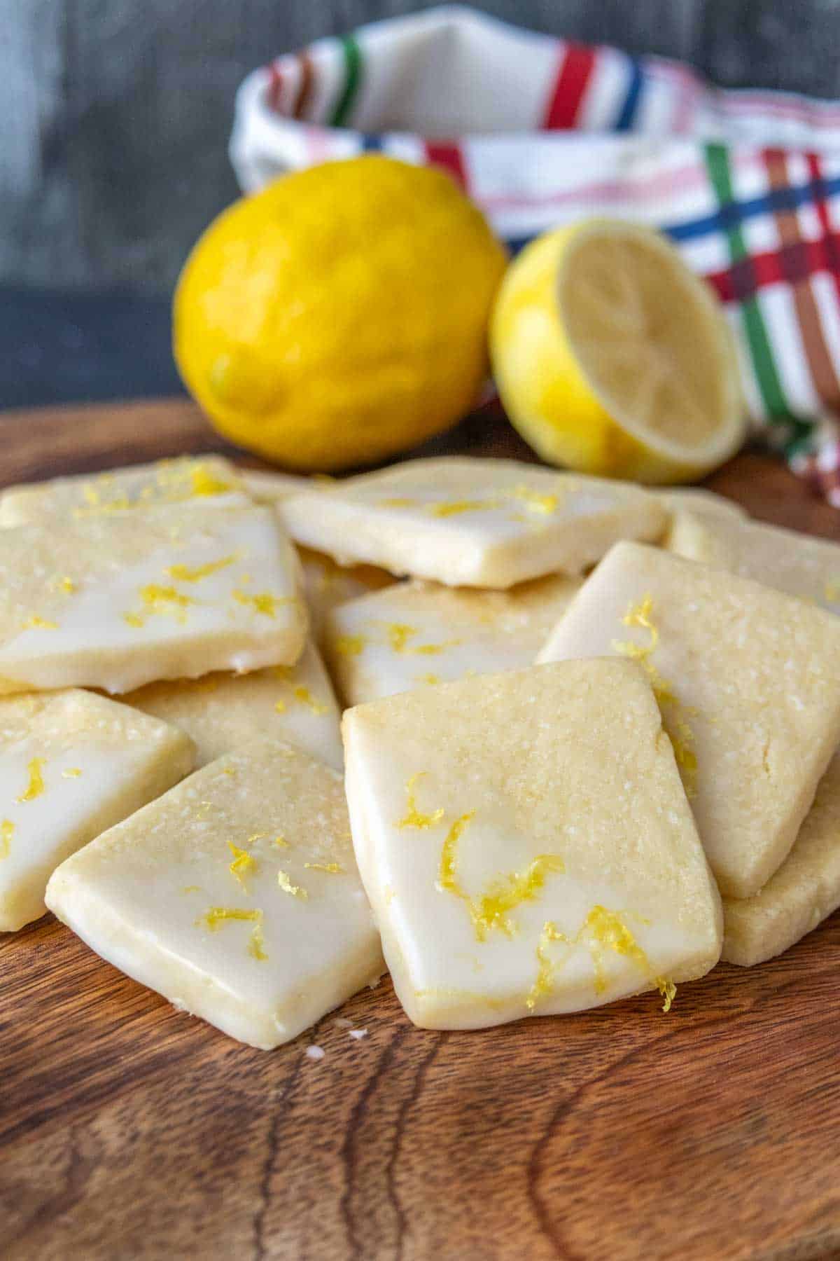 Lemon cookies on a wooden cutting board.