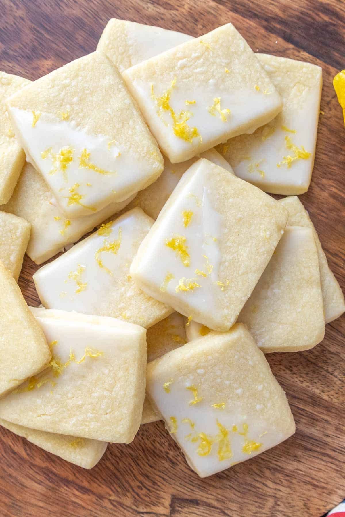 Lemon cookies on a wooden cutting board.