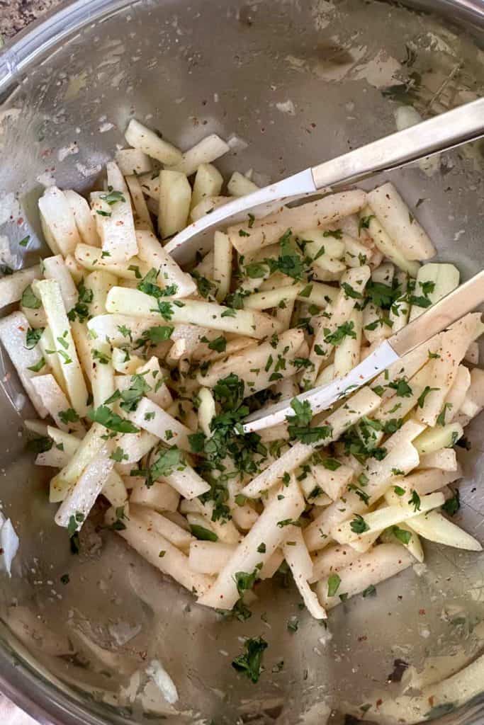 A bowl full of jicama and apples.