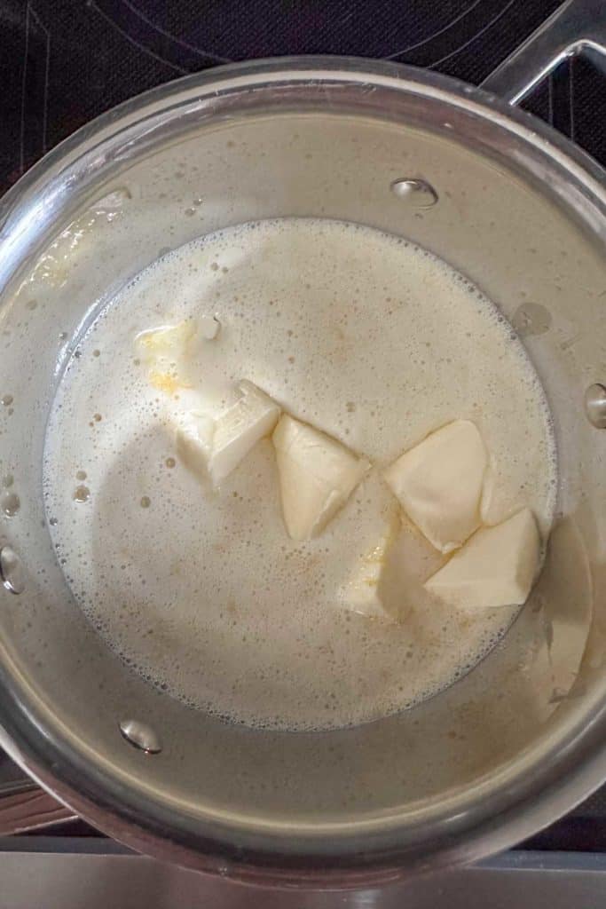 Butter in a pot on a stove top.