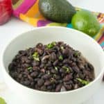 Mexican black beans in a white bowl.