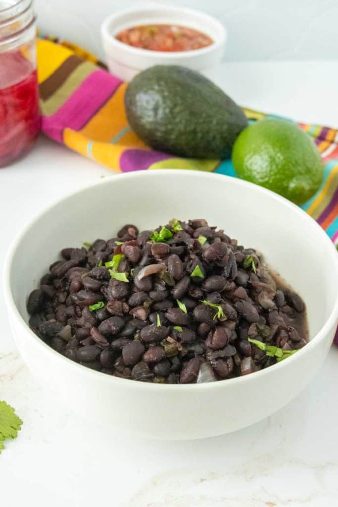 Mexican black beans in a white bowl.