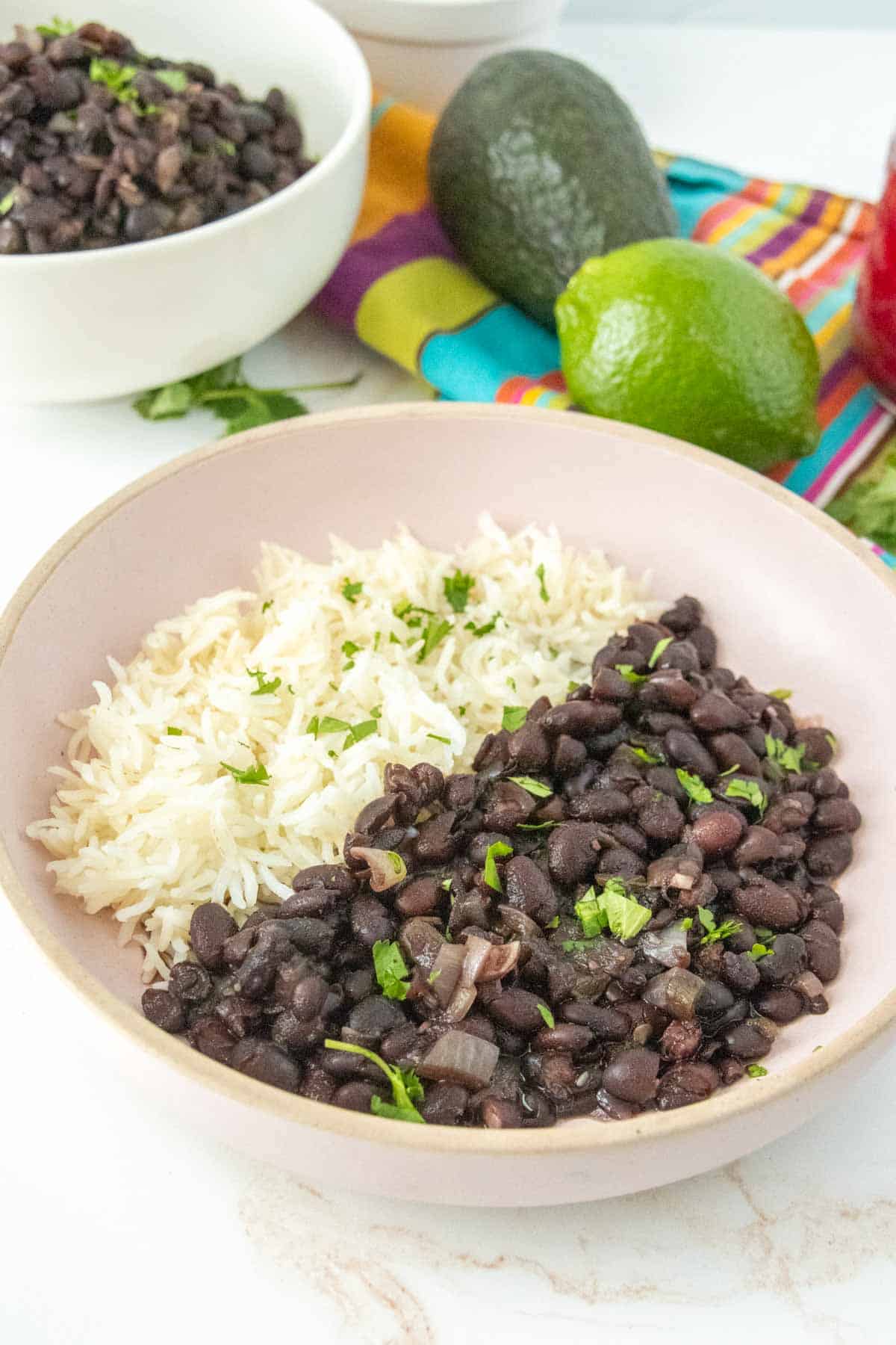 Black beans and rice in a pink bowl.