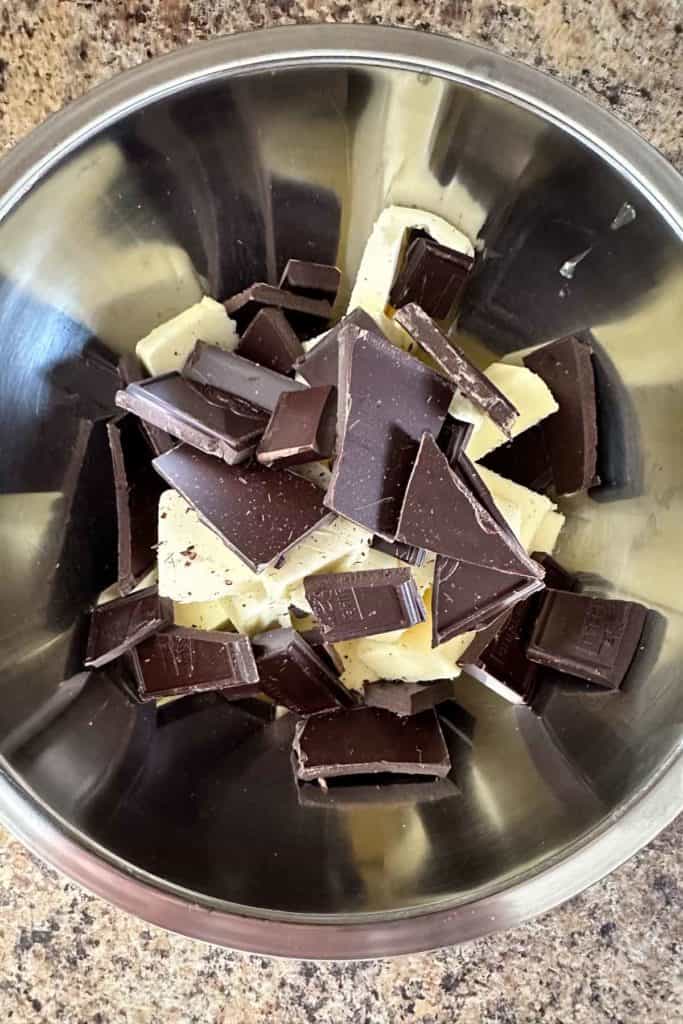Chocolate pieces in a bowl on a counter.