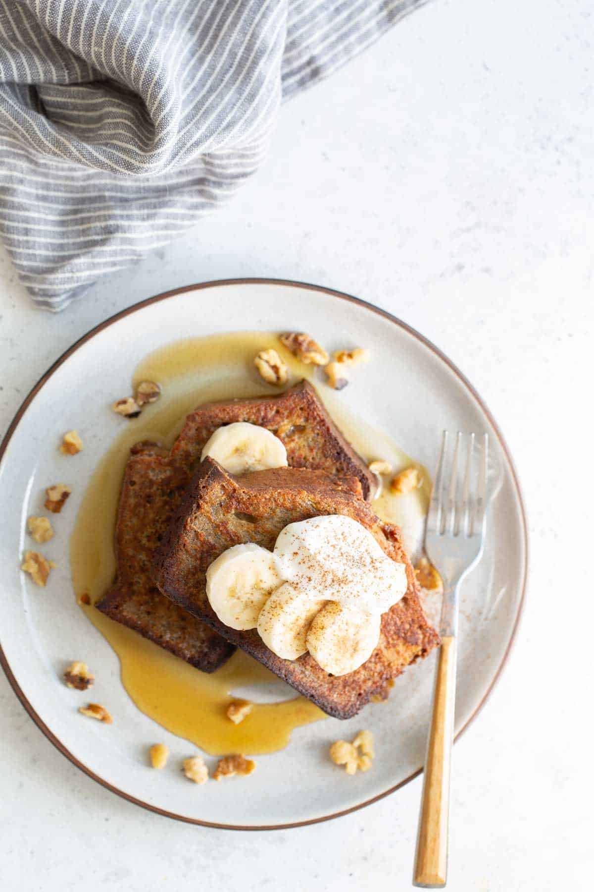 French toast with bananas and syrup on a plate.