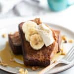 French toast topped with bananas and whipped cream.