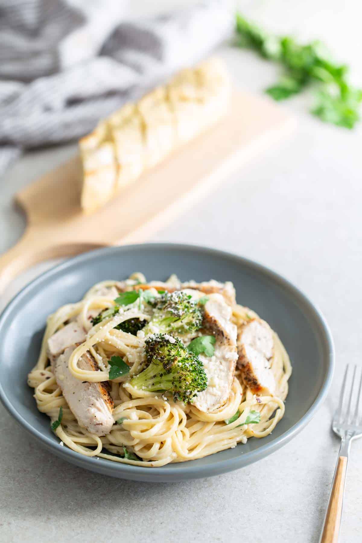 A plate of pasta with chicken and broccoli.
