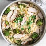 A pan with chicken and broccoli in it.