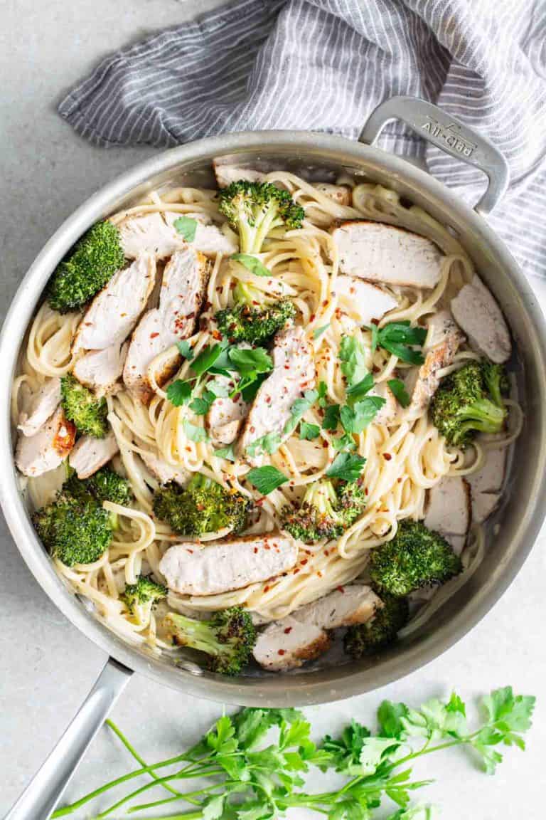 A pan with chicken and broccoli in it.