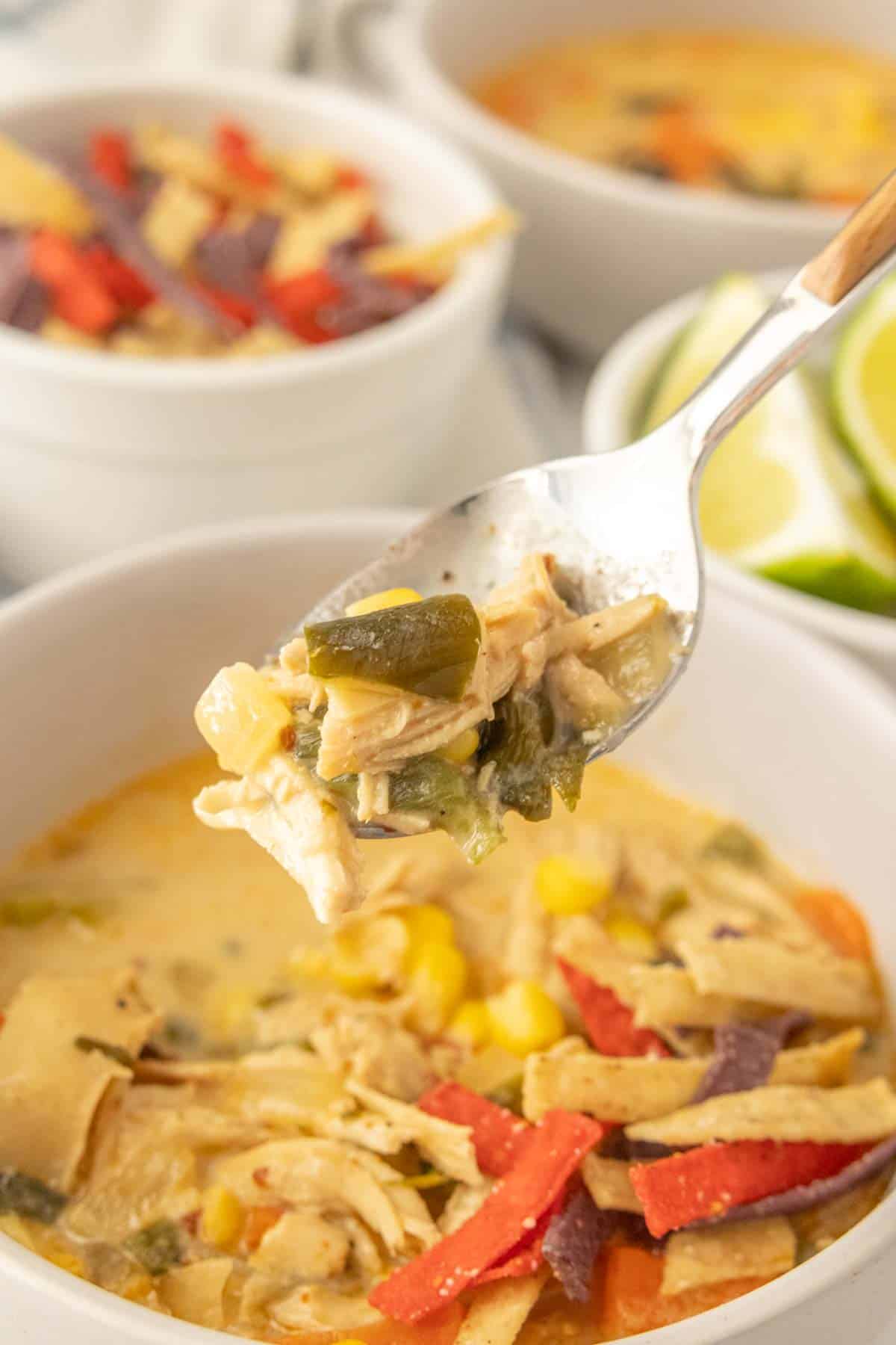 A spoonful of chicken poblano soup in a bowl.