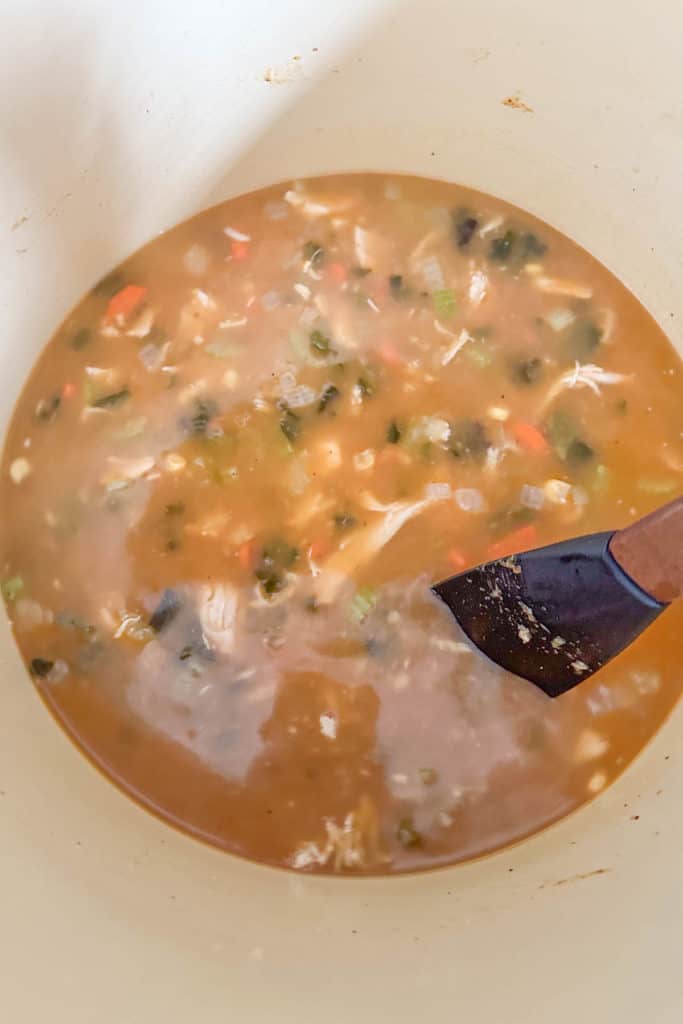 A bowl of soup with a spoon in it.