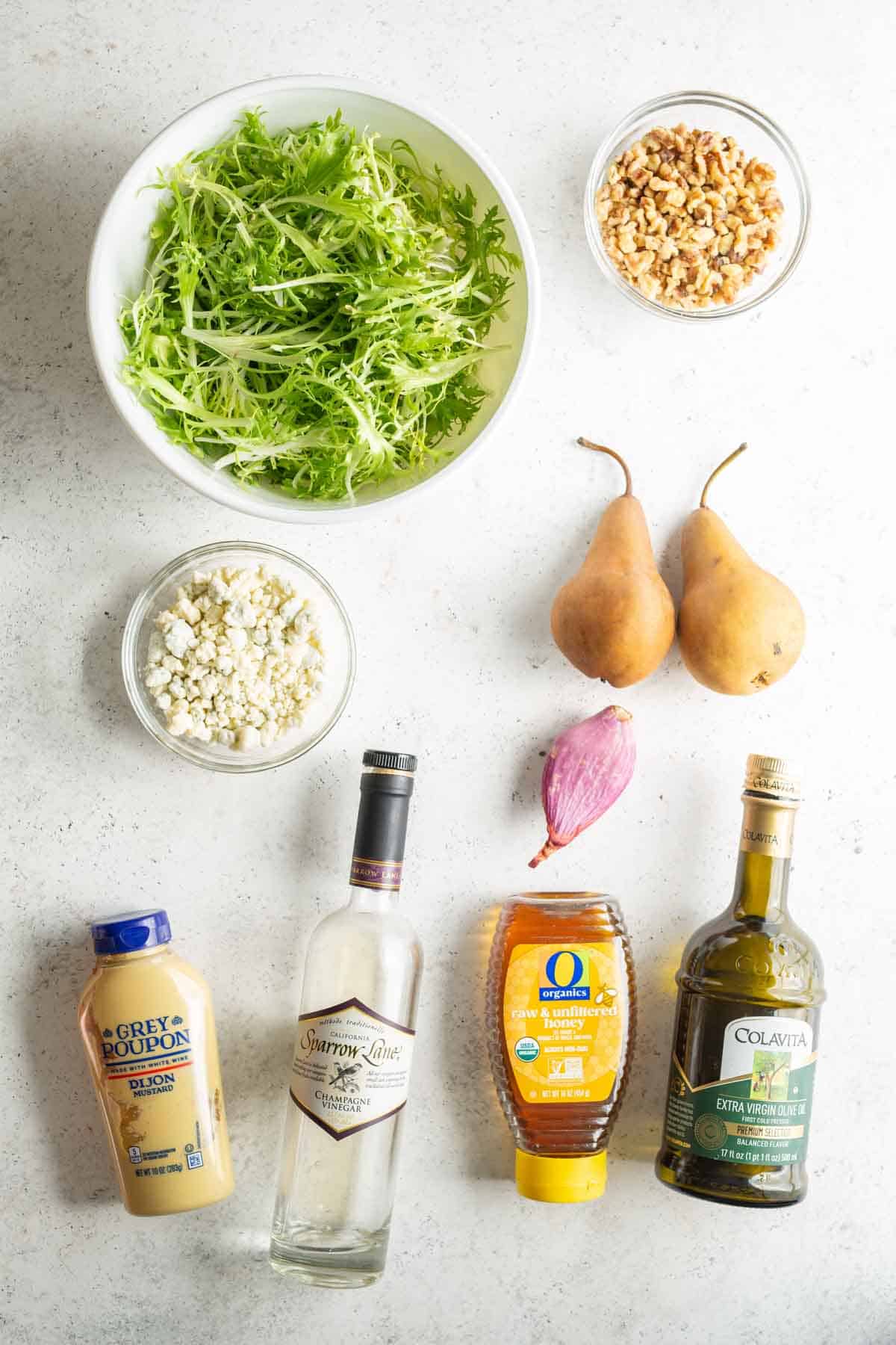 The ingredients for a salad are laid out on a table.