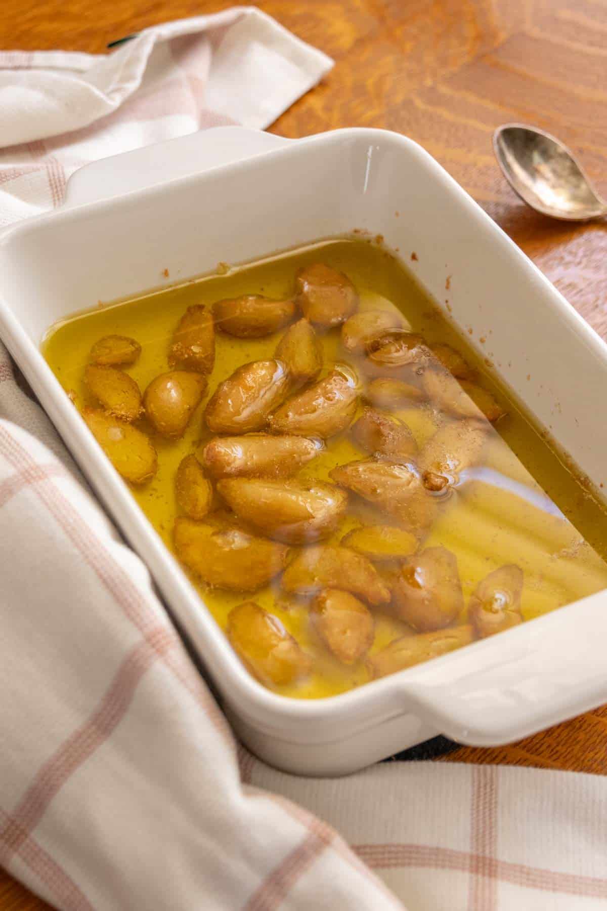 A white dish with garlic and oil.