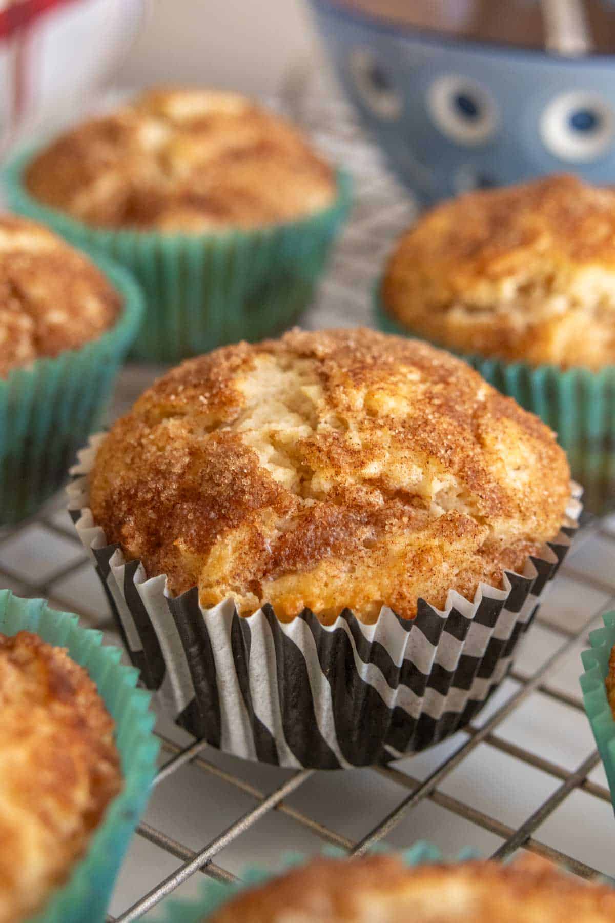 Cinnamon muffins on a cooling rack.