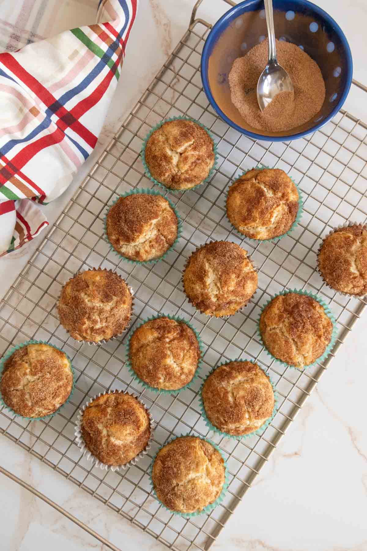 Cinnamon muffins on a cooling rack.