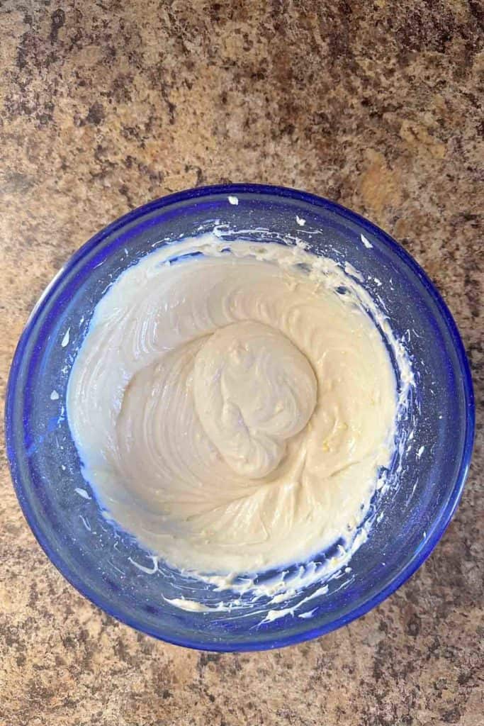 Batter mixed in a blue-rimmed bowl on a countertop.