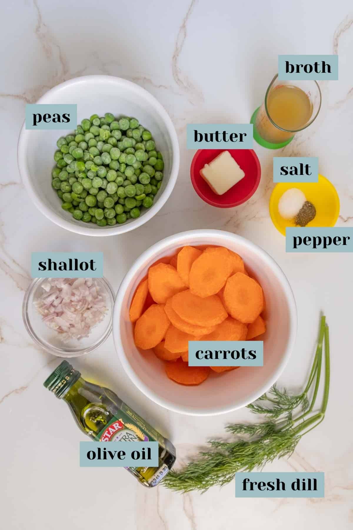 Assorted ingredients for cooking, labeled individually, laid out on a marble surface.
