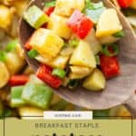 Close-up of a wooden spoon holding diced potatoes o'brien, green onions, red and green bell peppers, with text reading "Breakfast staple potatoes o'brien.