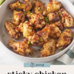 A bowl of sticky chicken wings garnished with chopped green onions, labeled "sticky chicken wings with plum jam" at the bottom.