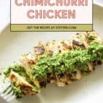 Sliced grilled chimichurri chicken breast topped with vibrant green chimichurri sauce on a white plate with a fork. Text overlay reads "Chimichurri Chicken. Get the recipe at stetted.com.