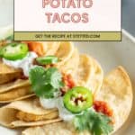A plate of crispy potato tacos topped with sour cream, salsa, jalapeño slices, and fresh cilantro sits on a table; "Potato Tacos" and recipe link appear above.