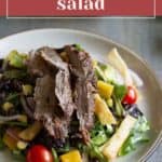 Plate of southwest salad topped with sliced grilled steak, assorted vegetables, cherry tomatoes, corn, and black beans, with bold "southwest salad" text above the colorful dish.