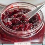 Open jar of blackberry jam with a knife inside, a plate of bread topped with sweet blackberry jam in the background, and the label "blackberry jam" at the bottom.