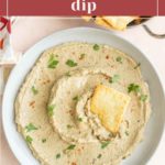 A bowl of smooth and creamy eggplant dip, garnished with fresh herbs, served alongside crispy crackers. The text on the image reads "Smooth & Creamy Eggplant Dip" and "stetted.com".